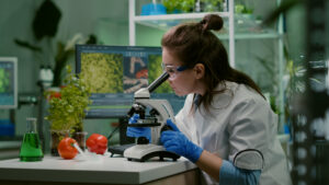 Portrait of biologist scientist in white coat working in expertise laboratory