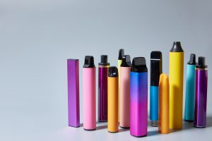 Vape e-cigarettes on a gray background with a place for text or product advertising
