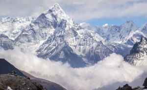 Ama Dablam mountain, sky, clouds, and hiker. Himalaya.