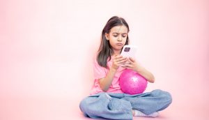 little-girl-with-smartphone-her-hands-pink-background-copy-space (1)